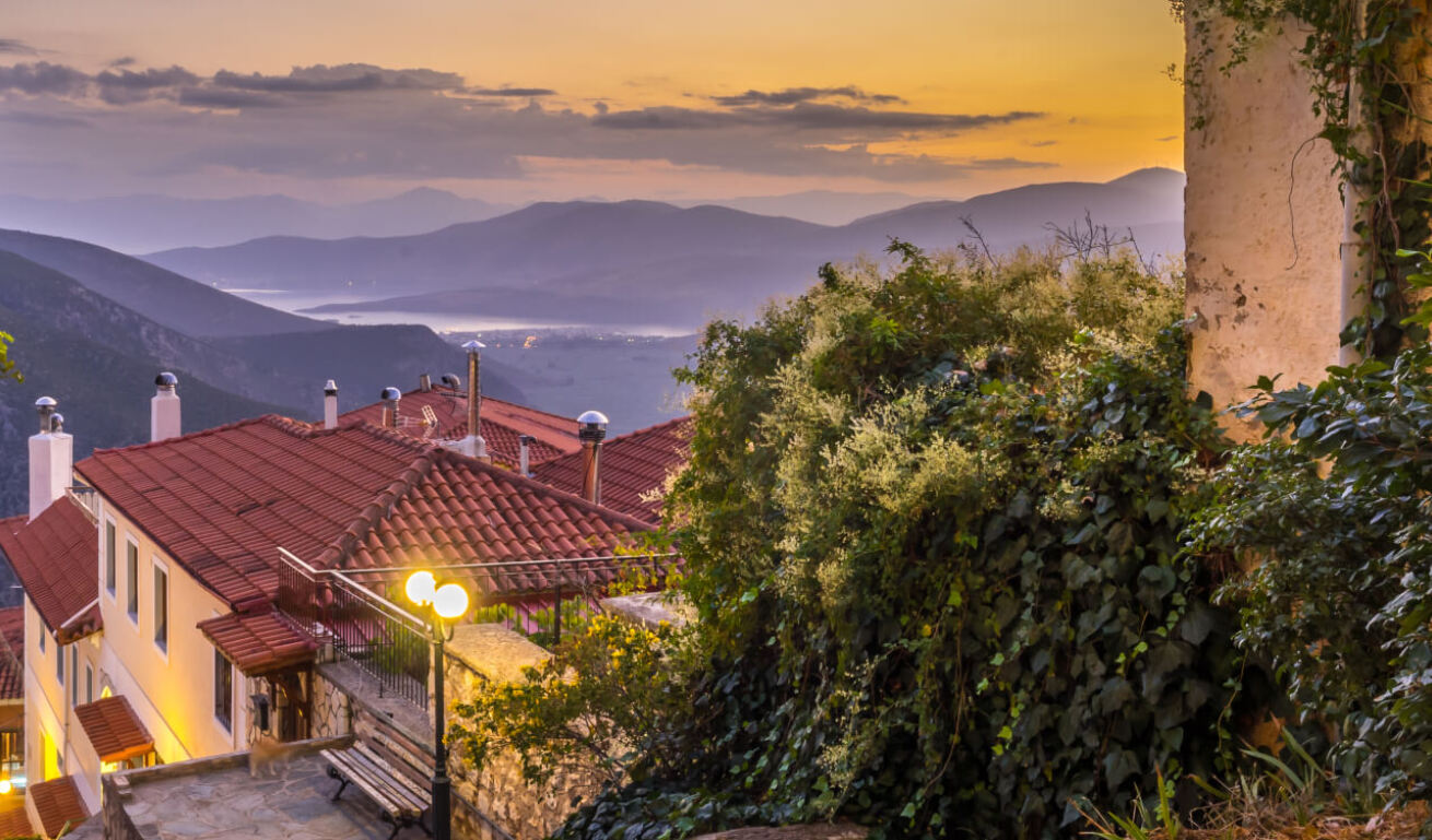 View of Delphi at dusk, with many houses with roof tiles