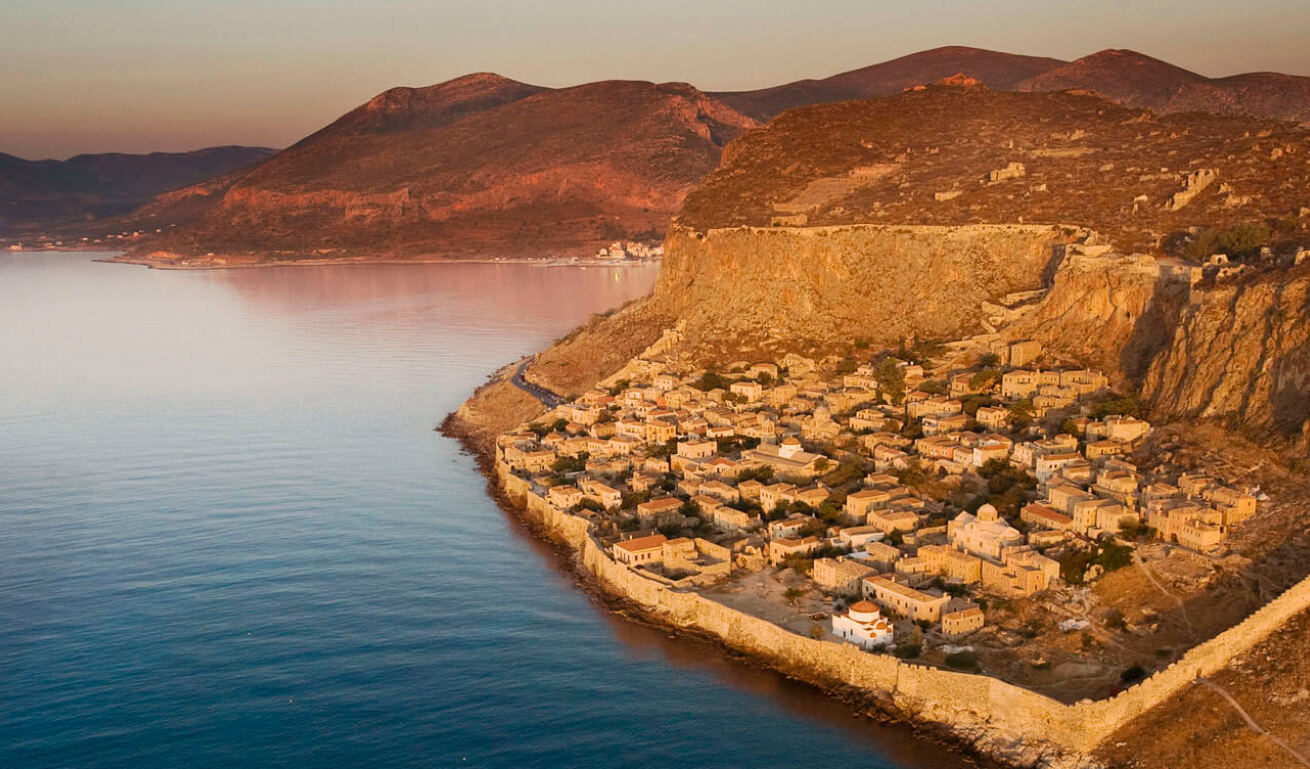 Stone settlement inside walls on a rock above the sea. 