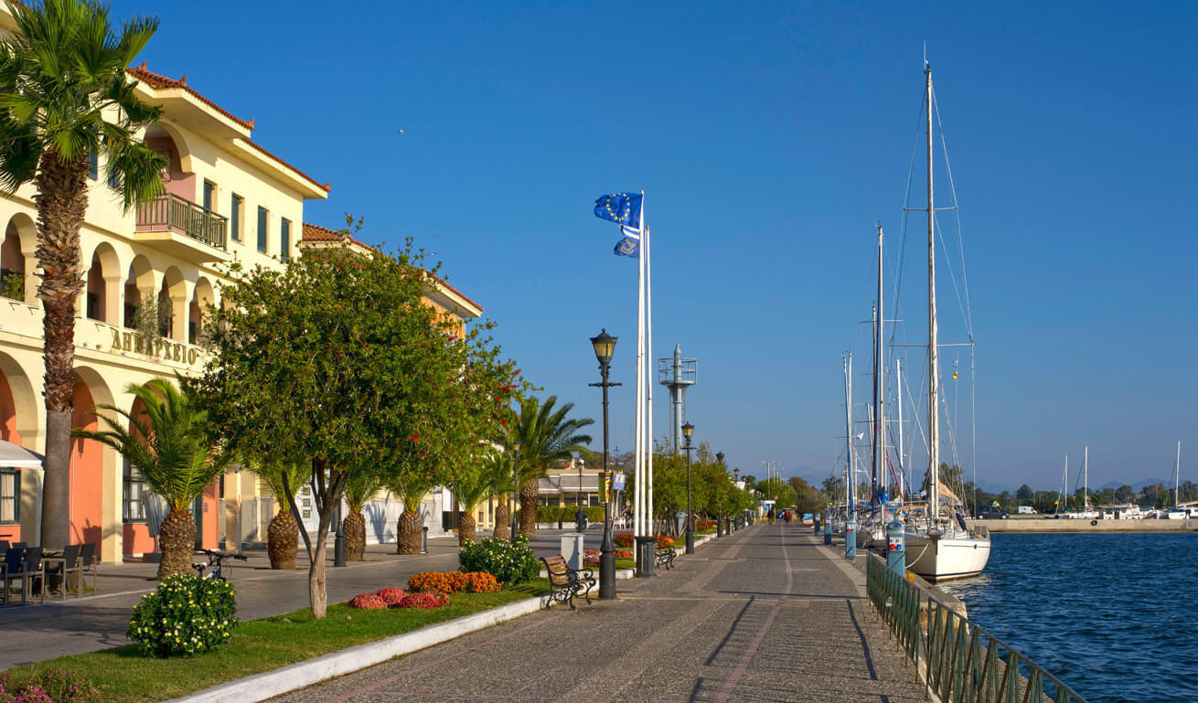 View of the seaside road and the port of the town, with the traditional houses and the town hall