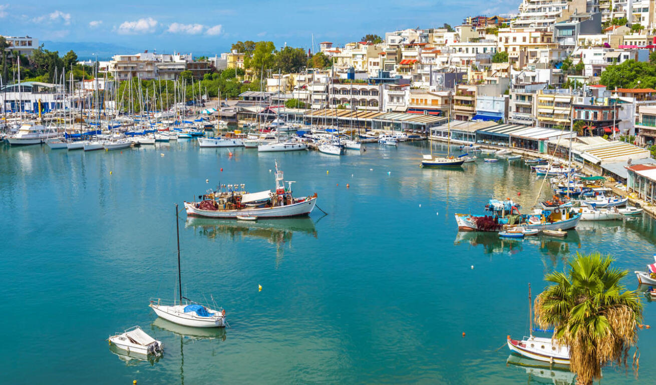 Mikrolimano from above, with boats and sailing boats anchored and in the background the densely built houses are shown