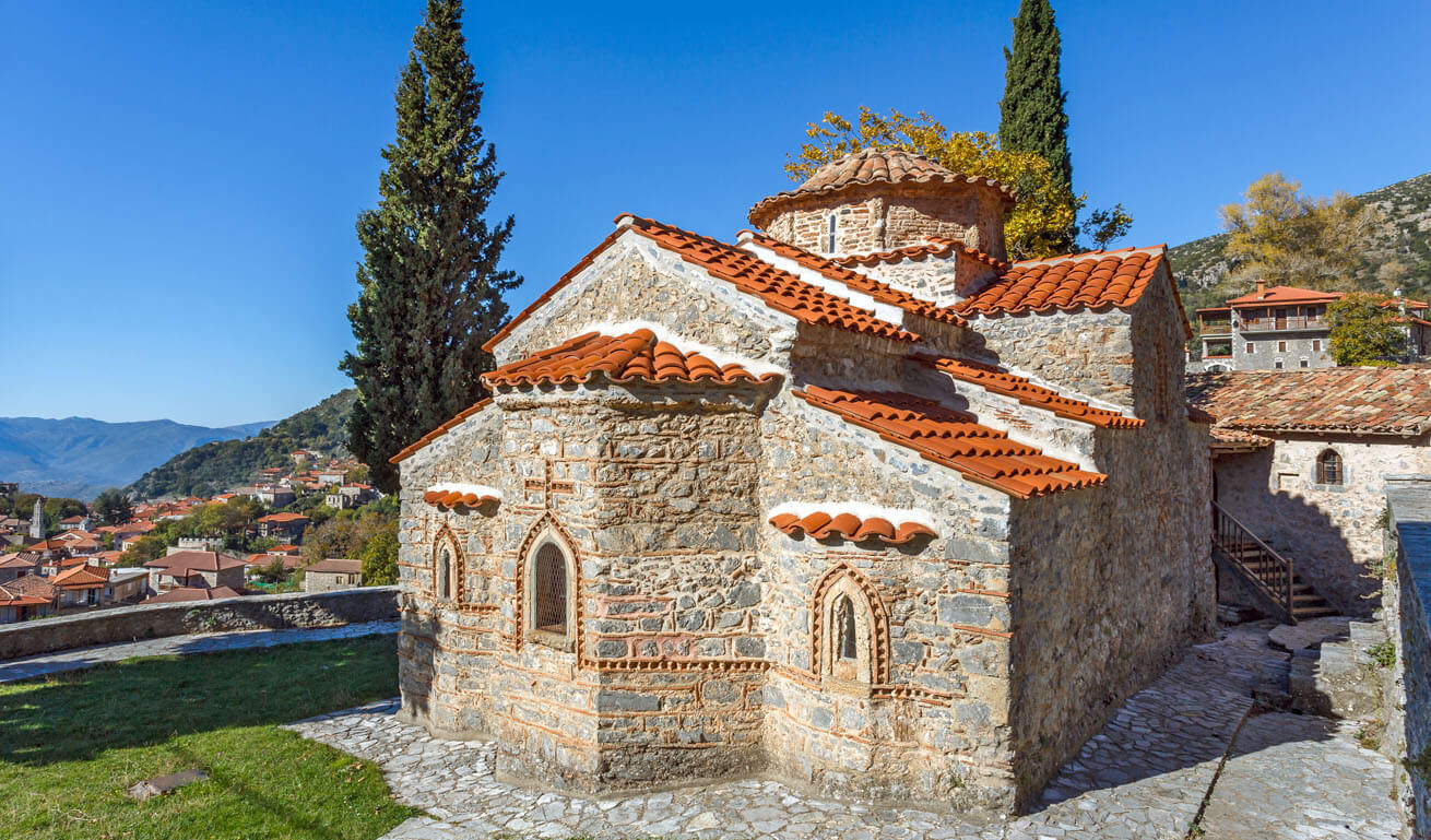 The church of Stemnitsa and in the background the traditional houses of the village