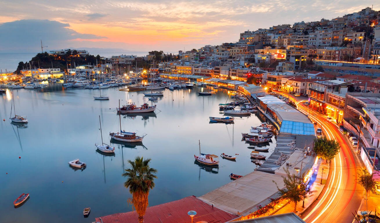 View of Mikrolimano in Piraeus, with many boats and sailing boats at dusk