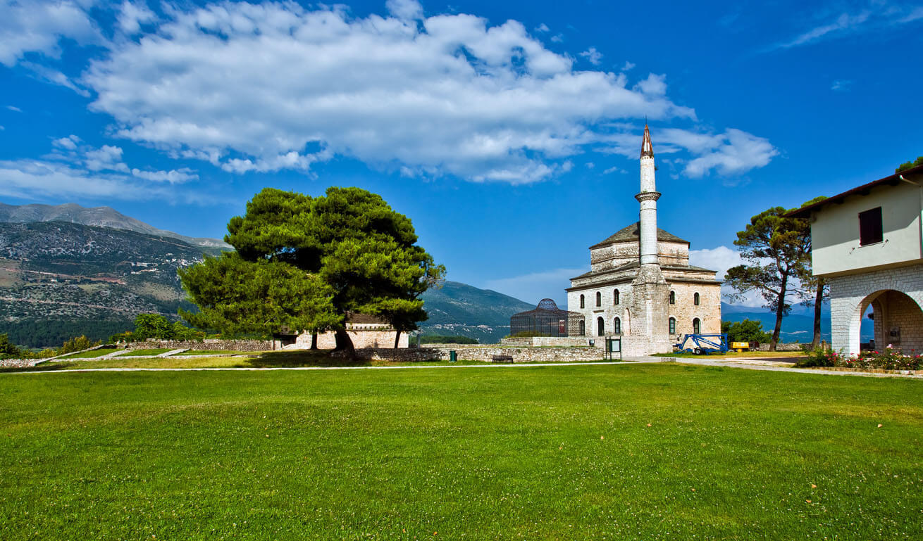 View of the town and in the background a mosque and next ti it a pine tree