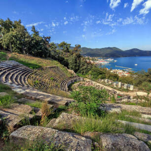 Ancient theatre with a village and the sea in the background