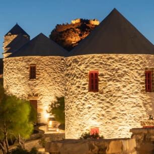 Illuminated windmills during dusk
