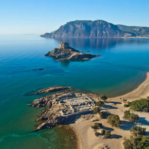 View of the beach of the island from above with greenish blue waters and islets