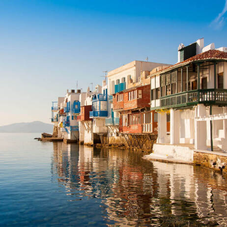 Small picturesque houses next to each other on the sea. 