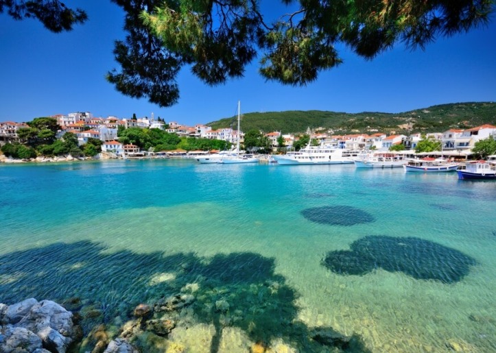 Sight of waterfront, sailboats and island town in the background
