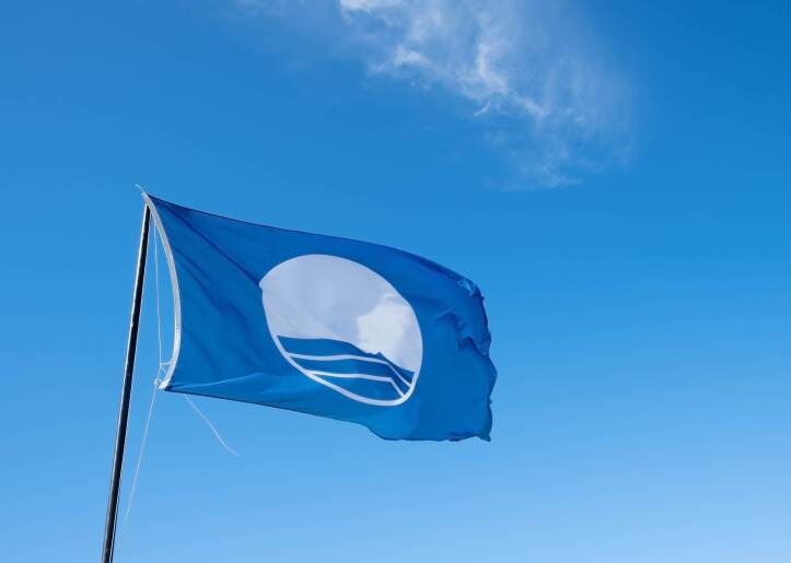an image showing a blue sky and a blue flag for clean beaches