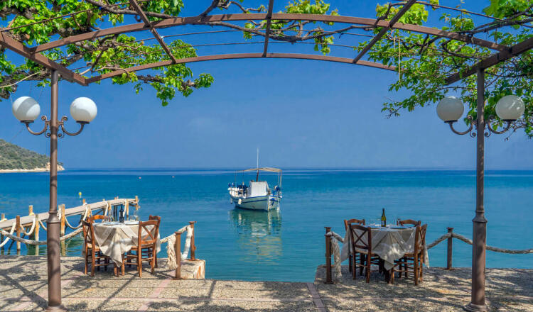 View of the beach of Epidaurus, with a fishing boat anchored near the beach