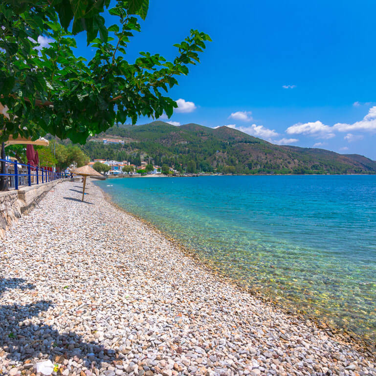 Tiny seaside town with a pebbled beach and greenish blue sea waters