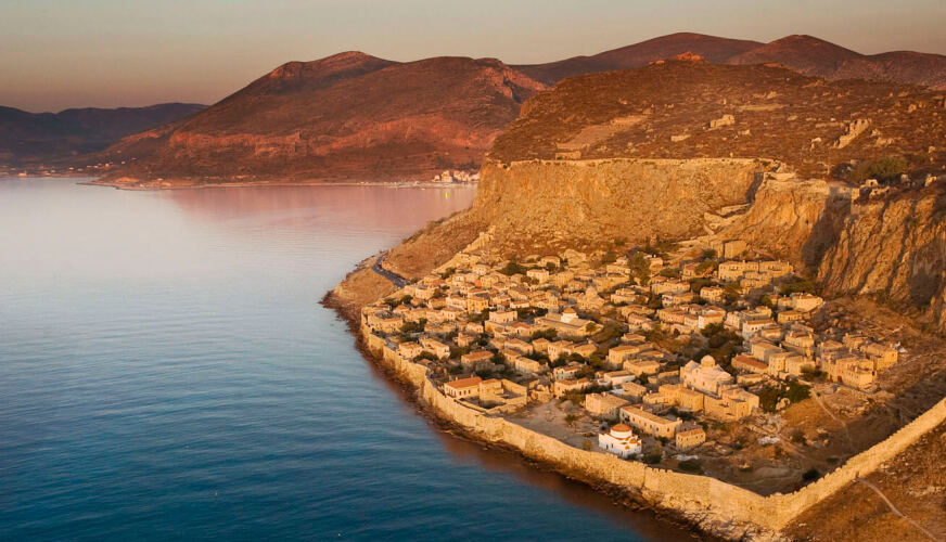 Stone settlement inside walls on a rock above the sea. 