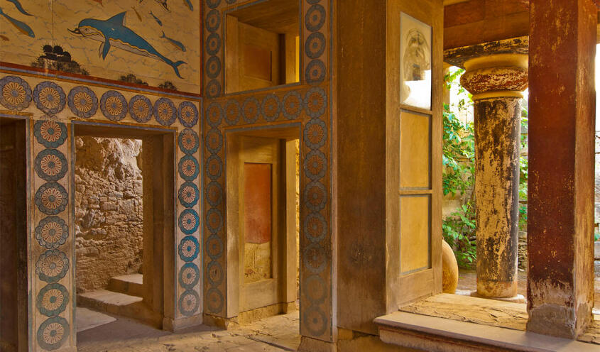 Interior of an ancient building with openings and frescoes on the walls