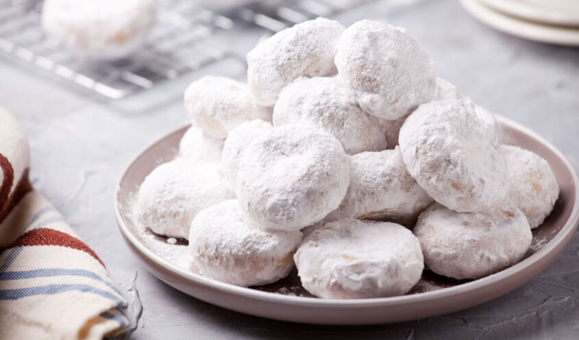 A dish with butter cookies called kourabiedes, typical greek cookies made during Christmas