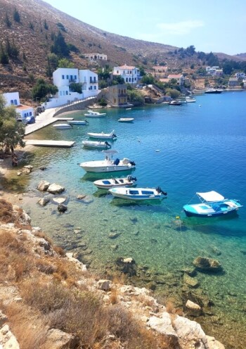 view of small seaside village with fishing boats in light green waters