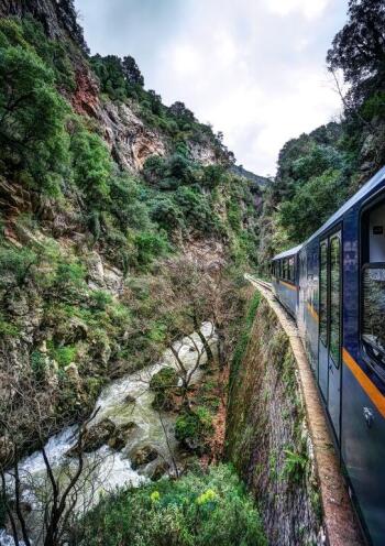 Odondotos train crossing the gorge under breathtaking cliffs